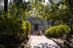 A reproduction of a temple or buildings set in a tropical outdoor part of the museum