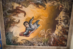 A mural of a boy who jumped to save The Mexican flag from capture by the American army on the ceiling of an atrium in Chapultepec Castle