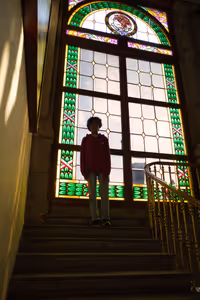 Aarav in front of stained glass windows and some stairs that led nowhere.