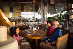 Getting seated to eat, as the sun sets.